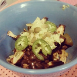 Homemade vegan chili fries...aka healthy vegan comfort food at its finest! Base of hannah yam 'fries' (baked with pink sea salt and cayenne), topped with homemade chocolate chili (made with black beans), homemade guac, pumpkin seeds and jalapeno. 